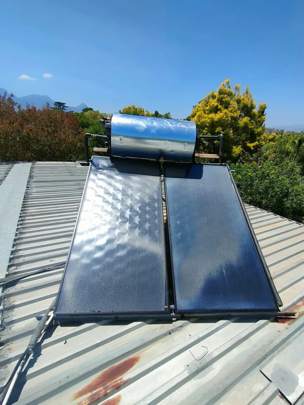 Solar water heating system installed on a roof